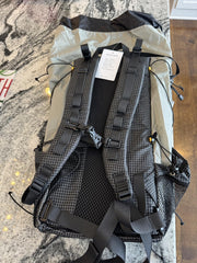 Backpack with visible brand tag on a textured surface