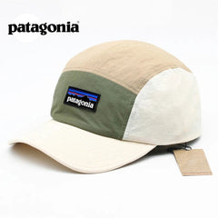 Beige and green cap with Patagonia logo on a white background
